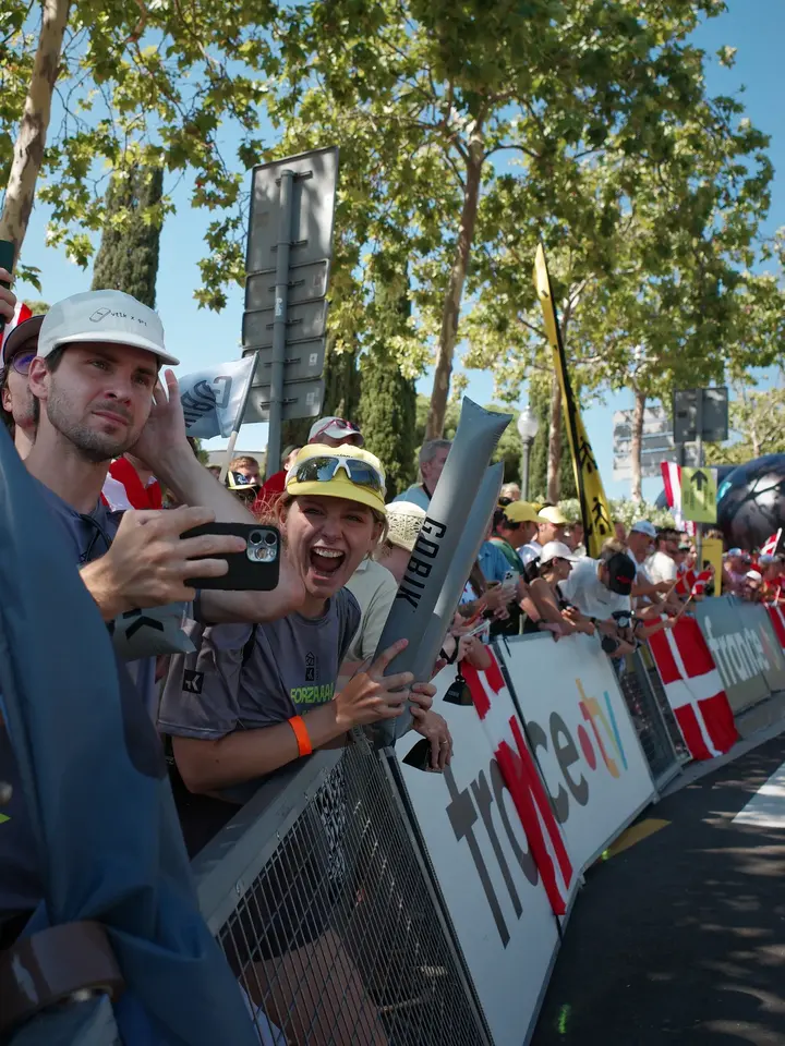 Spectators behind a barrier at a street race